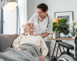 Compassionate nurse with elderly patient at home